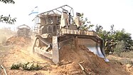 Bulldozer clearing trees in Gaza in 2023
