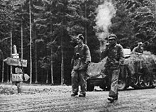 Waffen-SS Kampfgruppe Knittel pass through the Kaiserbaracke crossroads on the road between Saint-Vith and Malmedy to support Peiper in Stavelot. Kampfgruppe Knittel's troops on the road to Stavelot.jpg