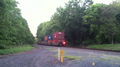 Norfolk Southern westbound train on the Lehigh Line passing through a crossing near Flemington, New Jersey, Picture 4- in back of train part two
