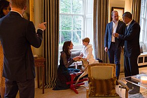 The Duke and Duchess of Cambridge, who reside in Apartment 1A, at the palace with Prince George and Prince Harry during a visit from President Barack Obama and First Lady Michelle Obama Obamas with the Royals (26515297651).jpg