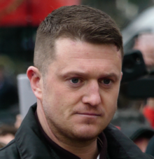 Tommy Robinson (pictured in 2018) became de facto leader of the EDL shortly after its formation Tommy Robinson at Speakers' Corner, Hyde Park.png
