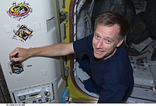 Ferguson signing the STS-126 patch on the ISS Chris Ferguson (29237626931).jpg