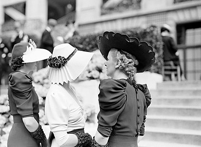 Three models in a fashion show for hats in Paris, 1936.