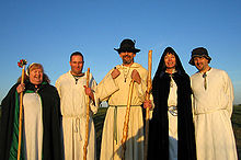 A group of druids of the Order of Bards Ovates and Druids in the early morning glow of the sun, shortly after having welcomed the sunrise at Stonehenge on the morning of the summer solstice. Druids, in the early morning glow of the sun.jpg