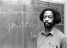 S. James Gates lectures from a chalkboard.