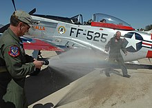 Greg Anders sprays his father with the fire hose after completing his last flight in 2008 Greg Anders sprays Bill Anders with the fire hose.jpg