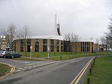 The Chaplaincy Centre, with its iconic spire and three lobes Lancaster University Chaplaincy Centre 1024.jpg