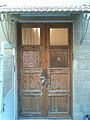 Wooden door entrance to first floor decorated with magen david and the word Zion in Hebrew.