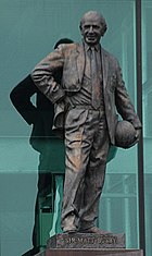 A statute of Sir Matt Busby holding a ball