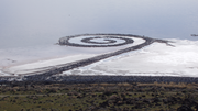 Robert Smithson's monumental graphic art earthwork Spiral Jetty (1970) is located on the Great Salt Lake in Utah. Using black basalt rocks and earth from the site, the artist created an artistic composition in the translucent red water with a graphic design 1,500 feet long and 15 feet wide.