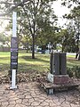 A small memorial within Lang Park, west of Queen street, which commemorates the men and women who worked at the St Marys munitions factory during World War II. A sign is inscribed with the story of the factory's development during the war and the significance of its remnants in the present day; beside the sign is a trolley carrying four bomb shell casings [38]