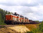 A trio of Dr16 diesel-electric locomotives hauling a 5200-ton Kostamus-to-Raahe taconite train up the Hangas hill near Pikkarala station, in Oulu, Finland, on 1 September 2001.