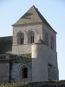 View of the three-story Romanesque style "Hastings" tower. The upper story has two semi-circular windows on each of the four faces. The lower story has bays on three sides. A stairway is housed within the north-east turret.