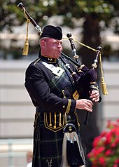 A bagpiper with the Naval Academy Pipes and Drums US Naval Academy Pipes and Drums bagpiper.jpg