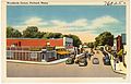 A postcard, dated between 1930 and 1945, showing a northwestern view of Woodfords Corner, with Forest Avenue being crossed by Woodford Avenue.