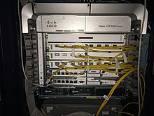 Rack containing a service-provider-class router connected to multiple networks ASR9006.jpg