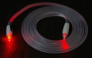 A TOSLINK fiber optic cable with a clear jacke...
