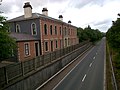 The station building and platform in 2014 with a bypass road along the former trackbed