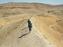 Geologists exploring Jurassic sedimentary rocks in Makhtesh Gadol, Negev Desert, Israel MakhteshGadolJurassicRidge.JPG