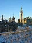 The East Block (left) and West Block (beyond), with its Mackenzie Tower, frame the south facade and Peace Tower of the Centre Block