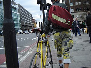 Cycle courier with yellow bike, London