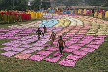 Children playing amongst drying colored cloth in Bangladesh Childhood Joy.jpg