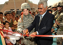 Celebratory proceedings in 2006 for the opening of a new women's center in Iraq, constructed by the Corps of Engineers Colonel Debra Lewis, a district commander with the Army Corps of Engineers and Sheik O'rhaman Hama Raheem.jpg