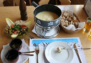 English: A full cheese fondue set in Switzerla...