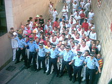 Police barrier at the beginning of the running stops people until the first rocket is fired. Sanfermin2006.jpg