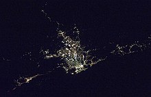 Sydney area at night, facing west. Wollongong is bottom left, and the Central Coast is at the far right. Satellite photo of the Greater Sydney Area at night.jpg