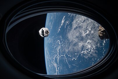 View of Crew Dragon Endeavour approaching the ISS with the Earth in the background as seen from Crew Dragon Resilience