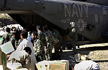 US Navy 051021-F-9085B-053 Pakistani soldiers unload disaster relief supplies from a U.S. Navy MH-53 Sea Dragon helicopter at Balakot, Pakistan.jpg