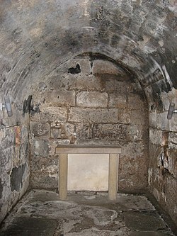 An underground stone lined crypt.