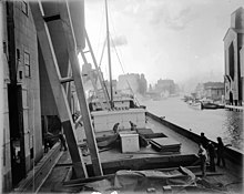 A ship is docked on a canal