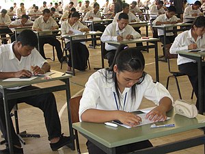 Young Cambodians doing an exam to be admitted ...