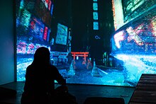 Photograph of person using controller to explore a 3D photogrammetry experience, Future Cities by DERIVE, recreating Tokyo Future-cities-best-76.jpg