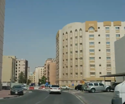 View of apartment buildings and a roundabout in Al Mansoura