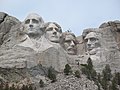 Some workers on top of Roosevelts head.