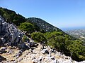 Fractured tectonic limestone by the path to Salakos. Middle Miocene-Pleistocene sediments on the plain below.