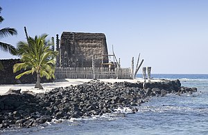 thatched structure with carvings at sea shore