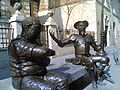 Don Quijote en Sancho vóór het geboortehuis van Cervantes