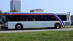 White bus with curved red, white and blue stripes