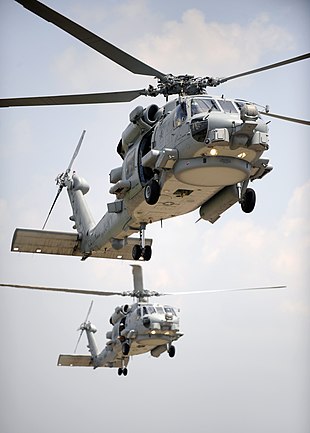 US Navy 090610-N-0413R-153 Two multi-mission MH-60R Sea Hawk helicopters fly in tandem during section landings at Naval Air Station Jacksonville, Fla.jpg