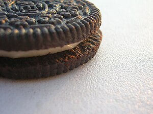 Photo of an Oreo cookie on a white table.