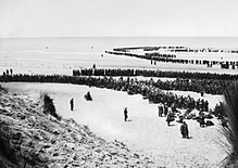 British troops line up on the beach at Dunkirk to await evacuation, 26-29 May 1940. Dunkirk 26-29 May 1940 NYP68075.jpg