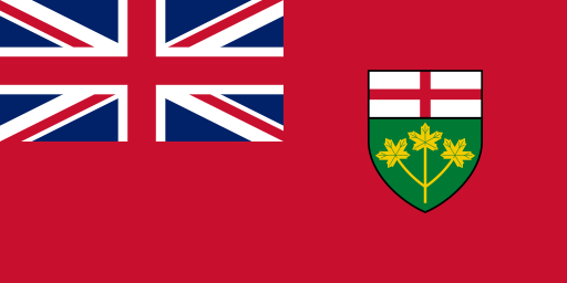 A red flag with a large Union Jack in the upper left corner as well as a shield in the centre-right