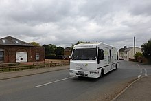 Lincolnshire mobile library at Pode Hole. Lincolnshire County Council operate five routes, covering small villages in this large, sparse, county. Each location is visited once a month. Mobile Library (geograph 3691202).jpg