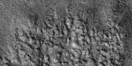 Closer view of ejecta, as seen by HiRISE under HiWish program Note: Arrows show examples of boulders sitting in pits.