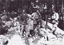 Three men in a mountain landscape