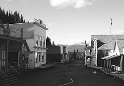 Barkerville's main street, taken in June 2004, showing the historic buildings and a small stream of water flowing down its sloped, unpaved, roads